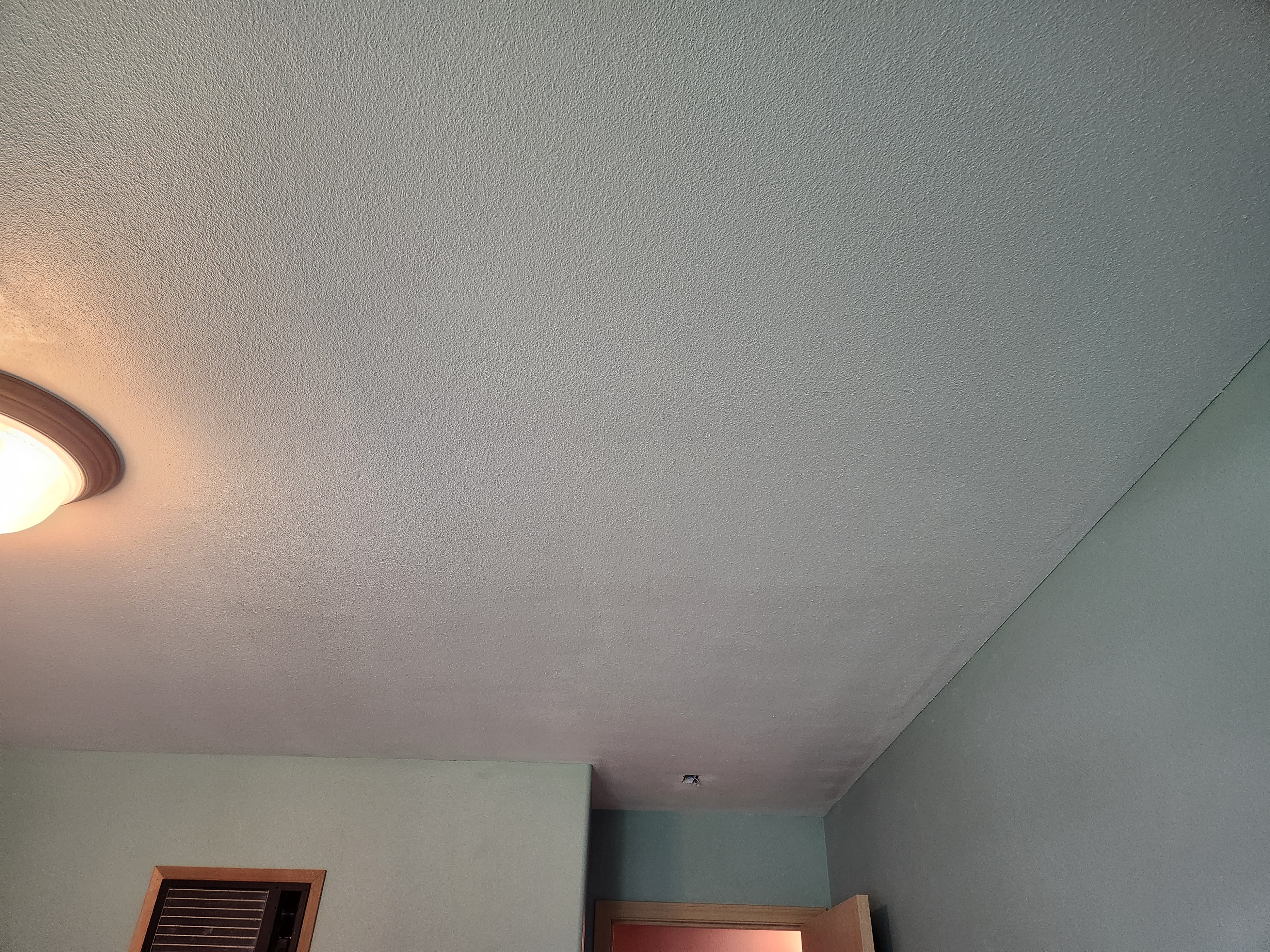 After drywall repair showing hole from plumbing work in residential ceiling in Kennewick